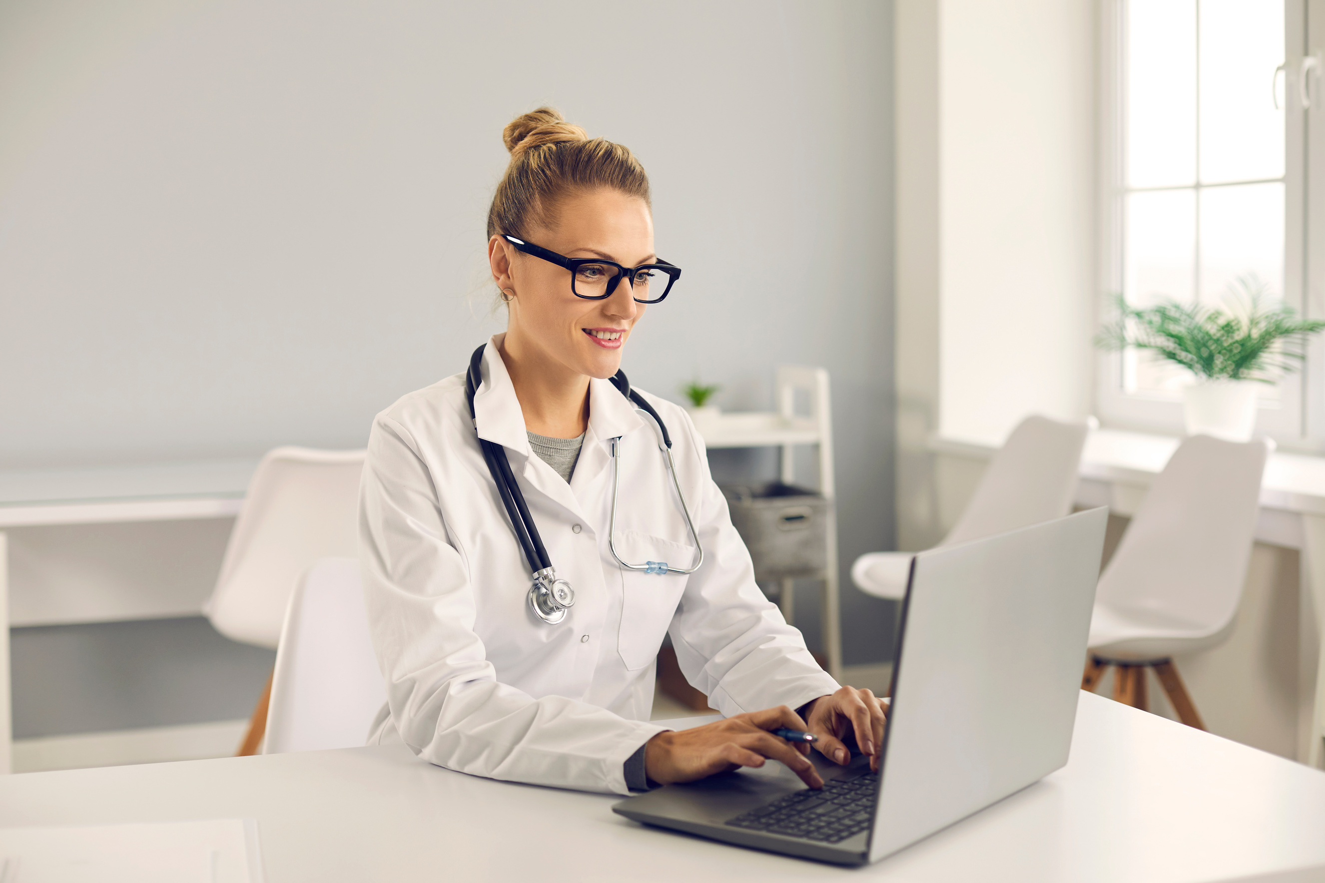 Doctor Giving Online Consultation or Working with Electronic Health Records on Laptop